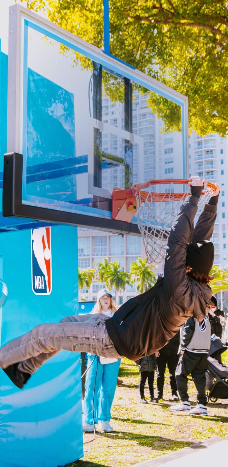 an NBA player holding a trophy in front of a crowd of people