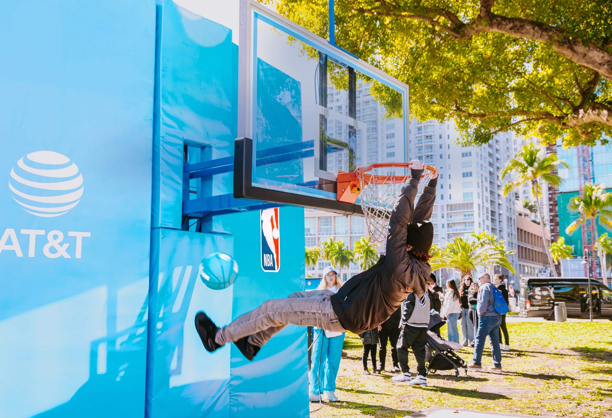 an NBA player holding a trophy in front of a crowd of people