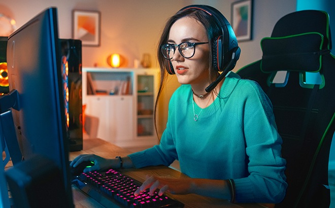 A lady with a headset on gaming