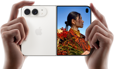 iPhone Duo, Star White color, held by two hands in horizontal orientation, unfolded, left panel shows 48MP Dual Fusion rear cameras, right panel shows person getting their picture taken on outer display, the subject of the photo is able to see their face as their picture is getting taken using Duo Preview