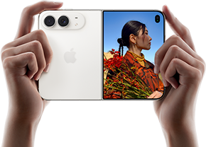 iPhone Duo, Star White color, held by two hands in horizontal orientation, unfolded, left panel shows 48MP Dual Fusion rear cameras, right panel shows person getting their picture taken on outer display, the subject of the photo is able to see their face as their picture is getting taken using Duo Preview