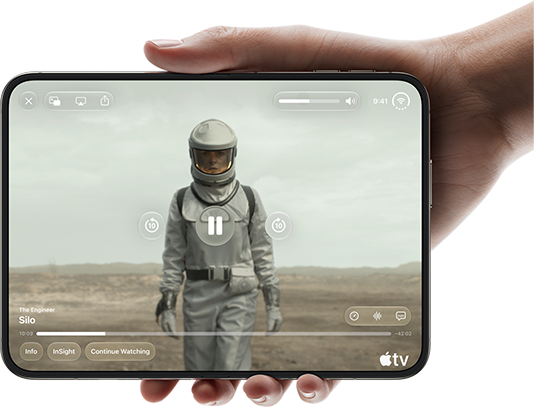 iPhone Duo, held with one hand, opened in horizontal orientation, fully unfolded, interior screen displays Apple TV show "Silo"