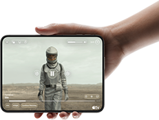 iPhone Duo, held with one hand, opened in horizontal orientation, fully unfolded, interior screen displays Apple TV show "Silo"