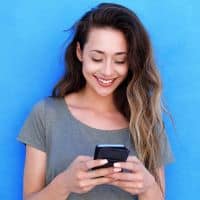 woman looking down at phone