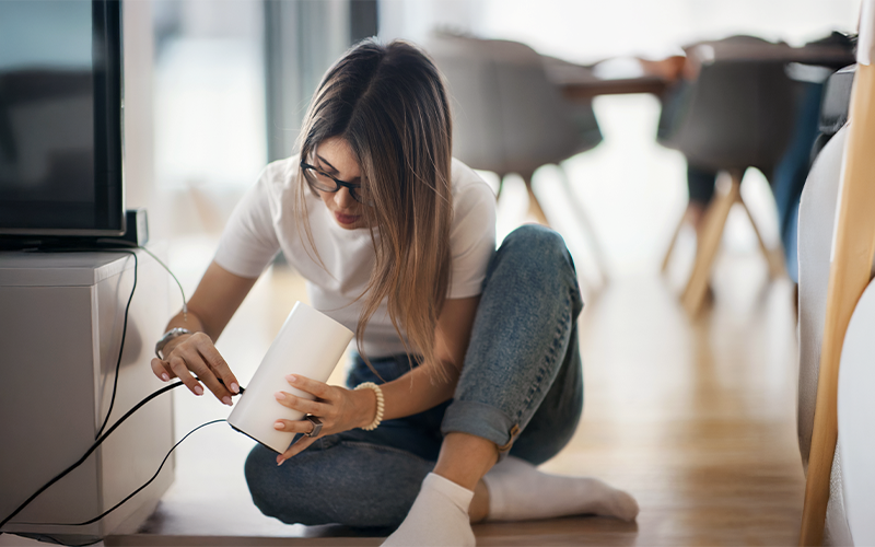 lady plugging in a All-Fi Hub