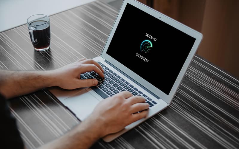opened laptop looking at internet speed test