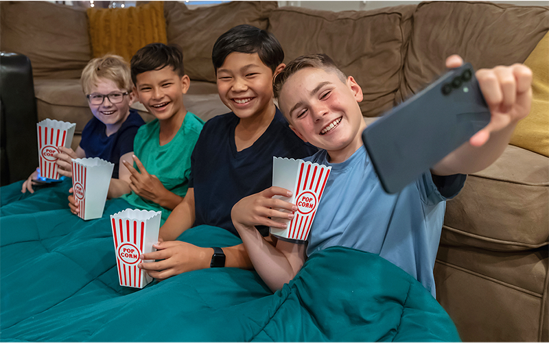 Kids taking selfie while eating pop corn