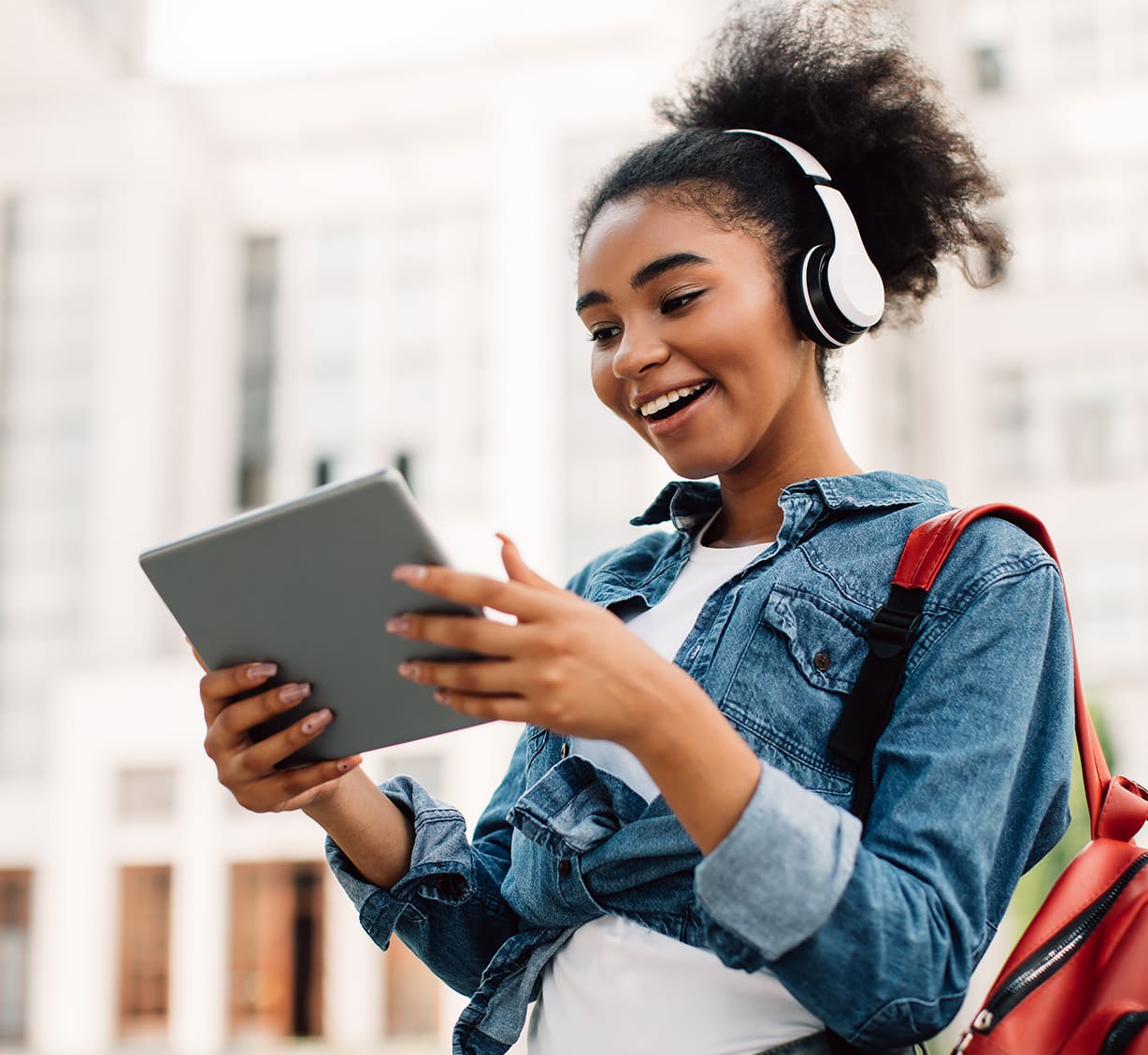 A girl looking at tablet and smiling