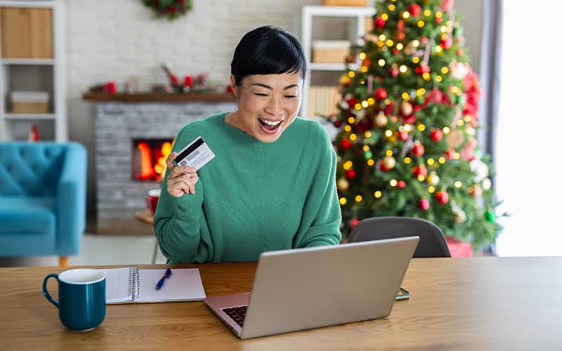 A Woman watching her laptop with joy
