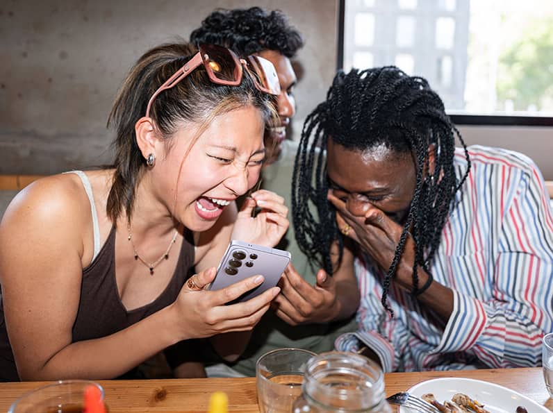 Watching phone and smiling